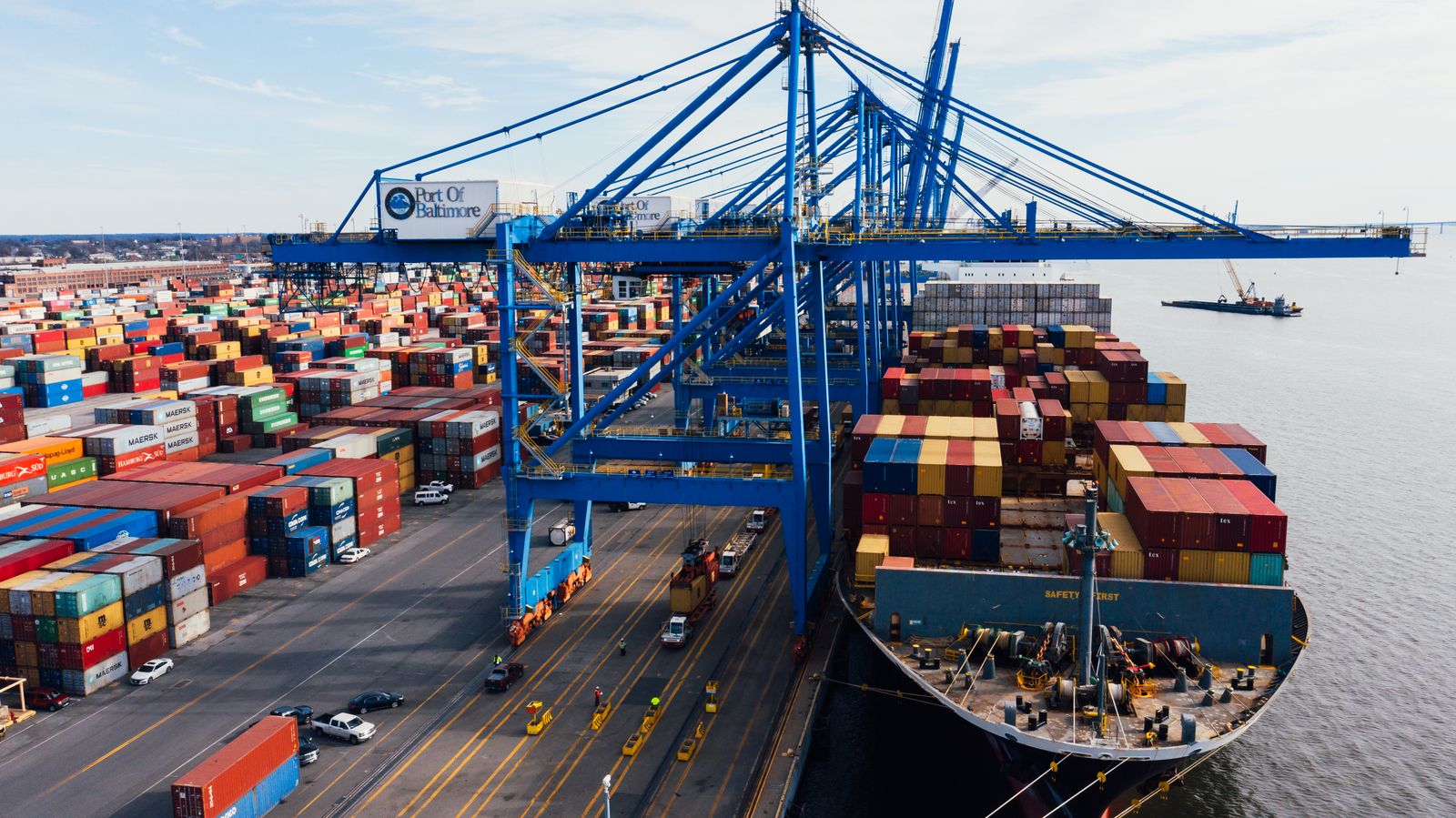 Container ship under the cranes of a port terminal